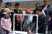 Students watch to see if water will travel faster through gravel or sand